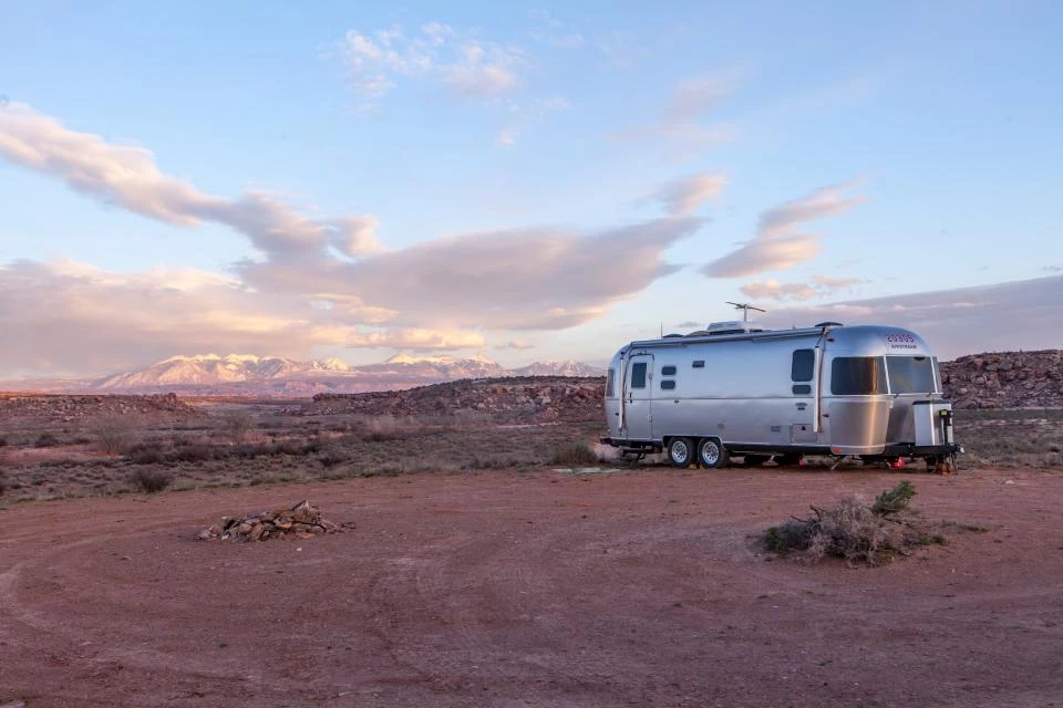 Travel trailer on a large empty field