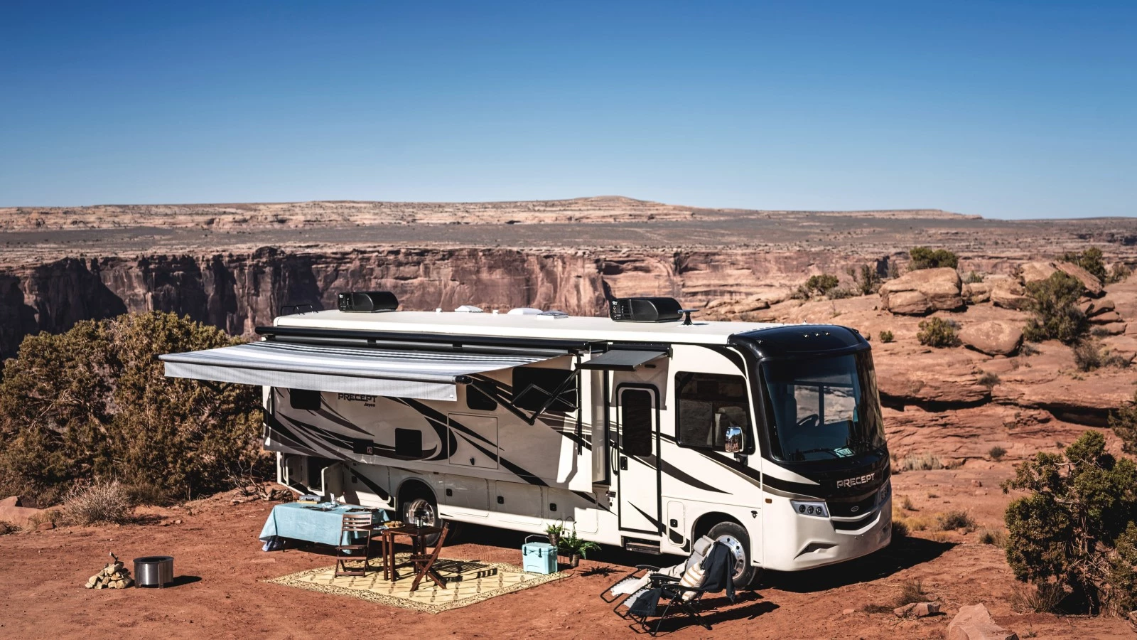 lateral view of a Class A Jayco Precept motorhome camped by a canyon