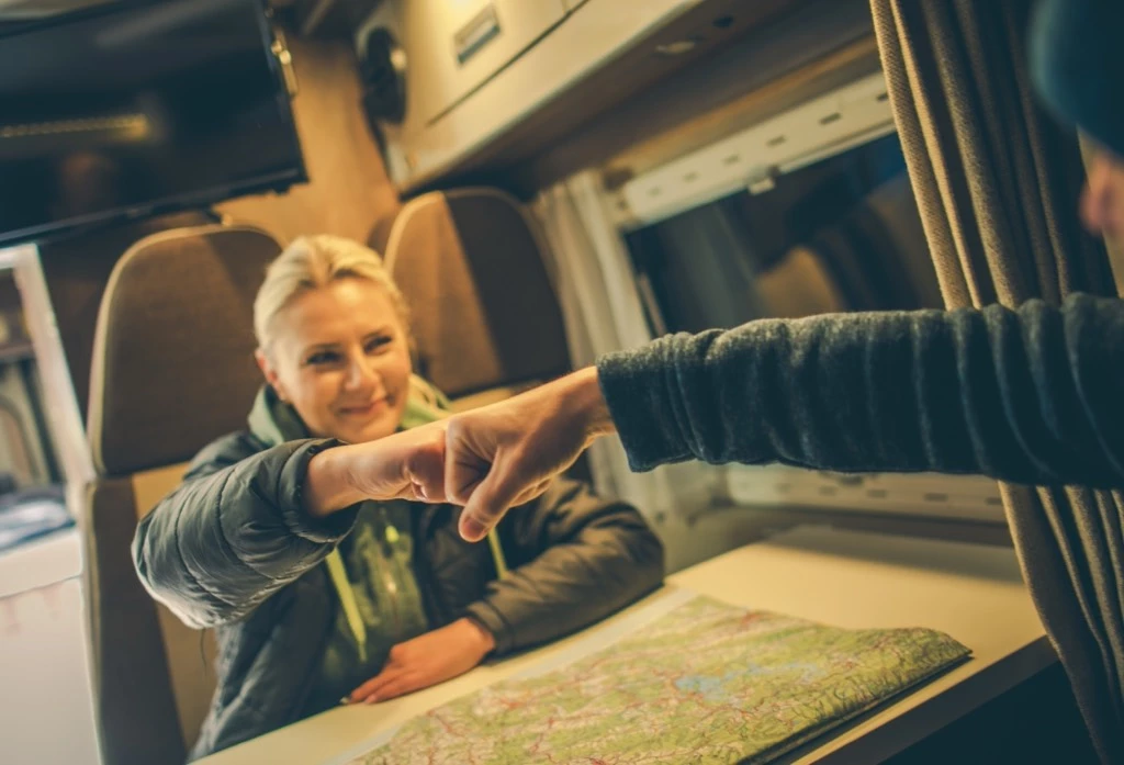 two friends organising their RV trip with a map