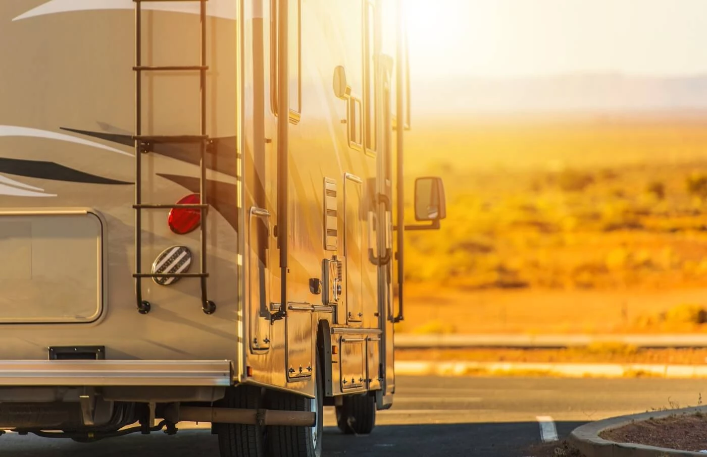 partial rear view of a motorhome driving down a road